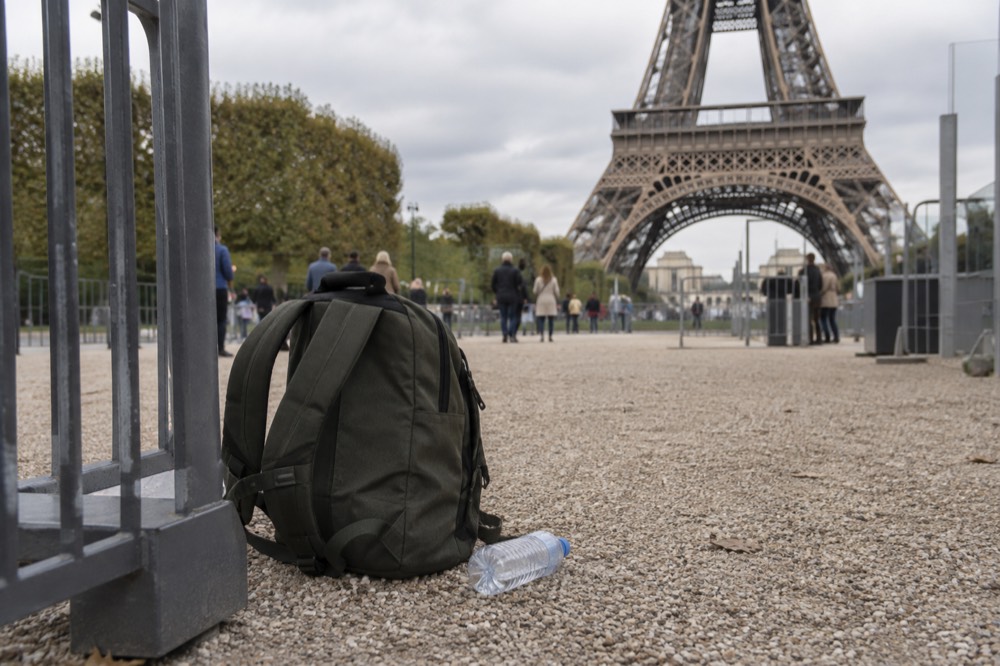 A rucksack on the ground at a security checkpoint on the Champ de Mars below the Eiffel Tower
