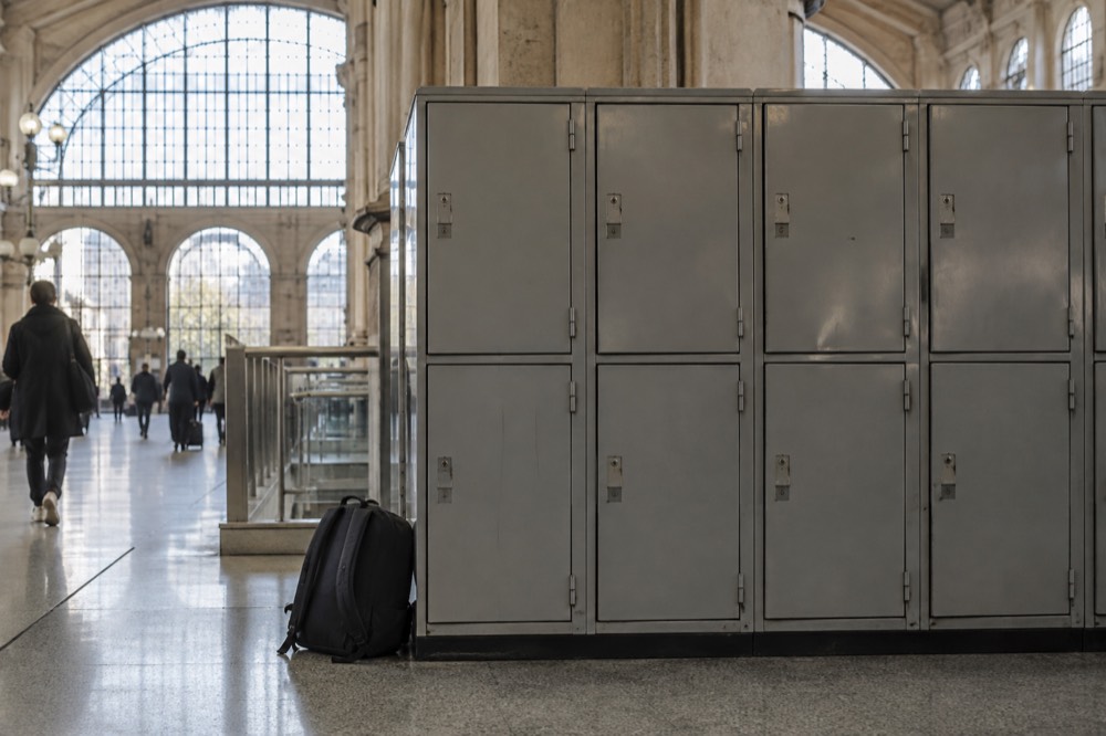A row of metal storage lockers inside a Paris train station