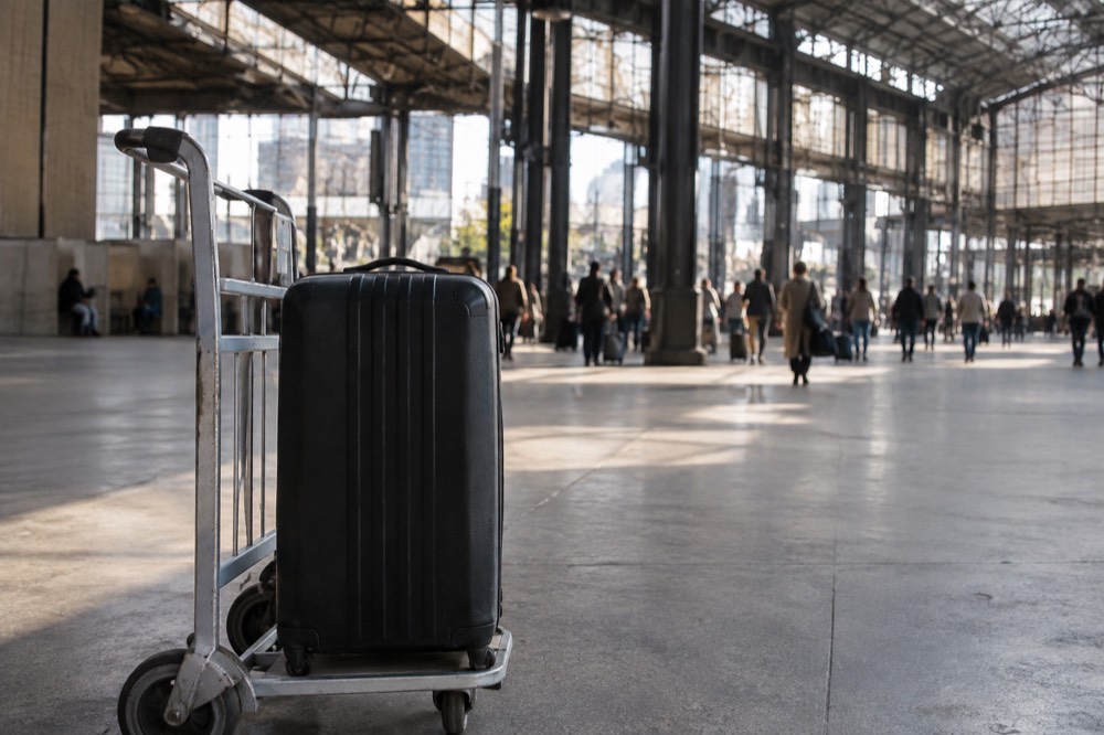 A suitcase on a trolley in an airport concourse near Paris