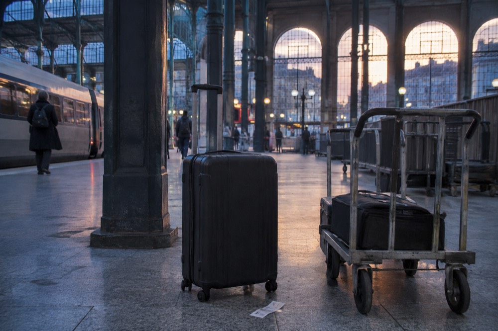 A traveller’s suitcase waiting in an empty Paris station concourse