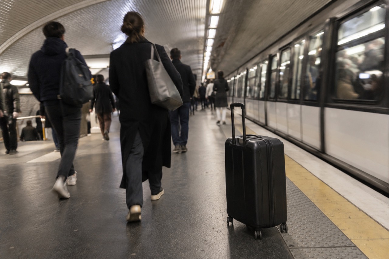 A Paris Metro platform with a suitcase resting beside the tracks