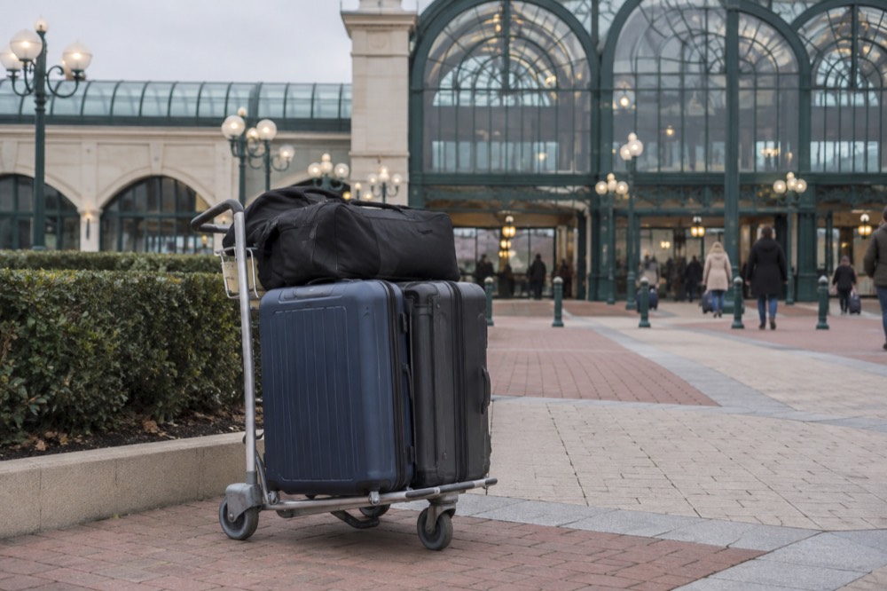 Hotel bell desk with trolley of suitcases in a resort lobby