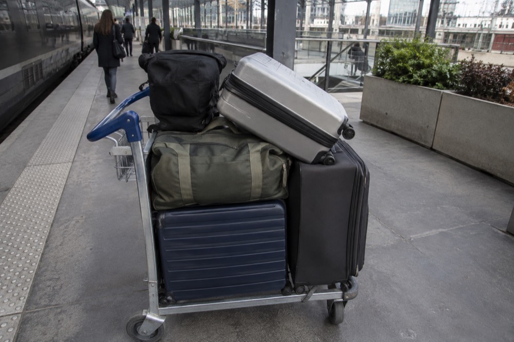 Cases loaded on a trolley at an airport shuttle platform near Paris