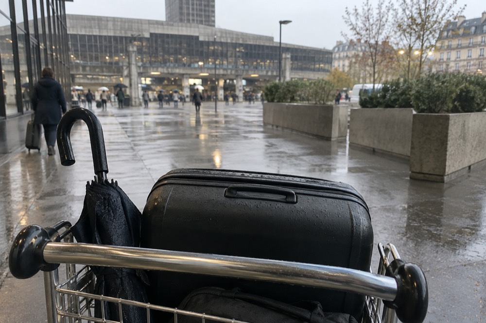 A suitcase on a trolley in an airport terminal walkway near Paris