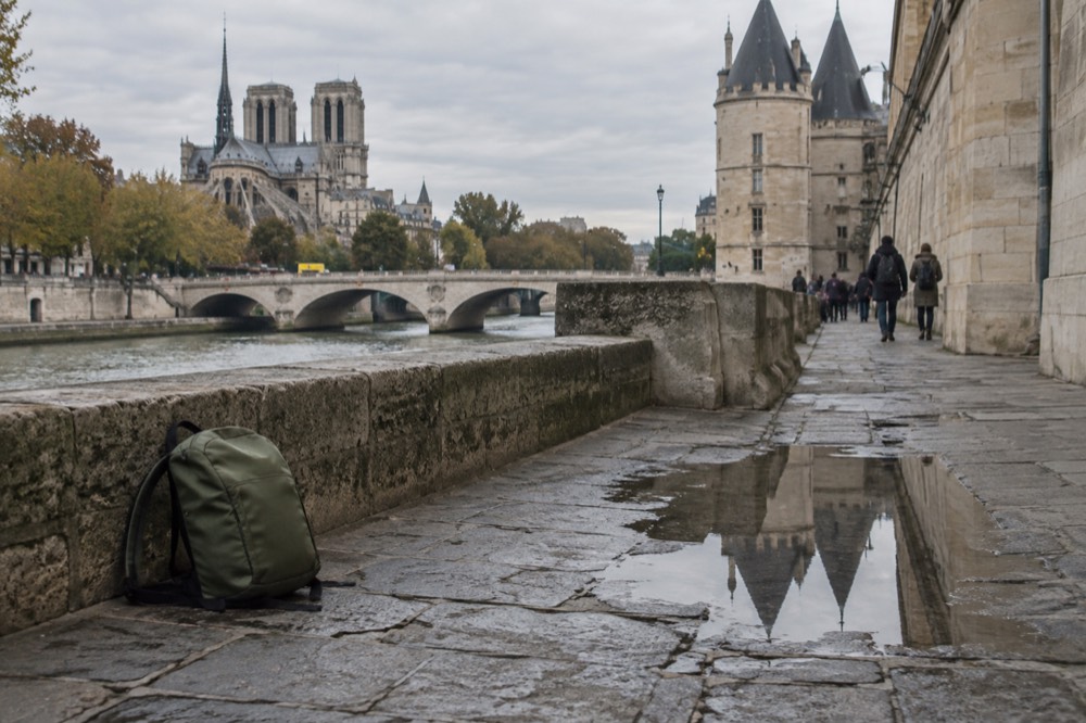 A rucksack on the stone embankment beside the Conciergerie in Paris
