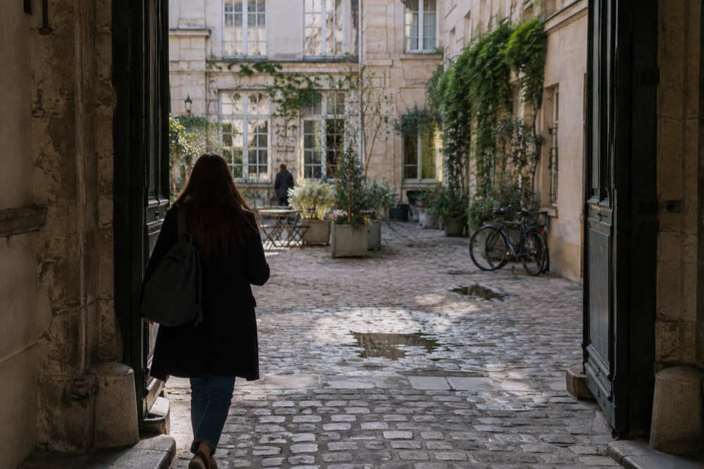 A small backpack carried through the ornate gilded gate at Versailles in morning light