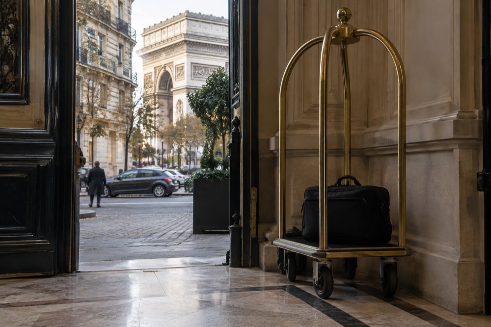 A laptop bag resting on a hotel luggage trolley